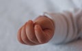 Soft focus of closeup closed baby hand lying relaxed.