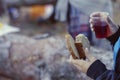 Soft focus. Defocused shot of children`s hands with pieces of bread and glass of cherry juice outside Royalty Free Stock Photo