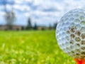 Soft focus f a grungy golf ball on a tee at a grassy field in Venango, Pennsylvania