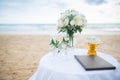 Flowers decorate at a wedding ceremony on the beach.