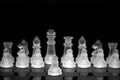 Soft focus of frosted glass chess pieces on a board against a black background Royalty Free Stock Photo