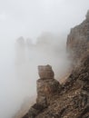 Ghost rocks. Awesome scenic mountain landscape with big cracked pointed stones closeup in misty morning. Sharp rocks background.