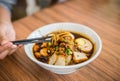 Soft focus hand with Chinese chopsticks eating noodle