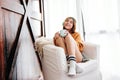 Soft Focus of Happy Young Woman Relaxing by Music Headphone from Smartphone on Sofa in Cozy House Royalty Free Stock Photo