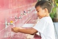 Asian child boy washing his hands before eating food. Royalty Free Stock Photo