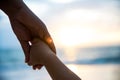 Soft focus parent hold the little child hand during sunset