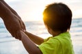 Soft focus parent hold the little child hand during sunset Royalty Free Stock Photo