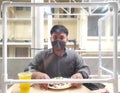 Soft focus on Partition on front of man wearing masks were eating lunch with partition