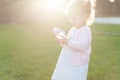 Soft focus photo of little curly girl with two tails walking in the backyard on the green grass Royalty Free Stock Photo