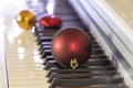 soft focus on piano keys with red christmas ball. new year or christmas music concept Royalty Free Stock Photo