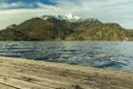 Soft focus picturesque north Europe Norway landscape rustic wooden pier with view on peaceful sea bay waters and mountain peak Royalty Free Stock Photo