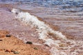 Soft focus sand stone ground coast line sea side beach with water waves fuzzy surface outdoor scenic background Royalty Free Stock Photo