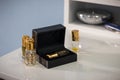 Soft focus of small perfume bottles with golden caps and a black box