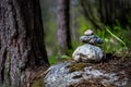 Soft focus of a stack of stones on a rock in the woods