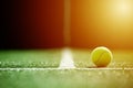 Soft focus of tennis ball on tennis grass court with sunlight Royalty Free Stock Photo