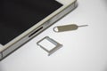 Soft Focus to SIM card or Subscriber identity module and SIM Ejector Tool From Smartphone