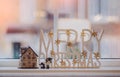 Soft focus Toy sheeps standing next to wooden house with blurry white wooden Merry Chritsmas background, Christmas holiday concept