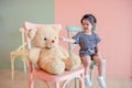 Soft Focus of a Two Years Old Child Sitting with her Teddy Bear.