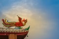 Soft focus view of Chinese phoenix statue on the roof in Chinese