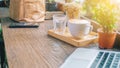 Soft focus a white cup of coffee on wooden table at cafe in the morning with space laptop smartphone Royalty Free Stock Photo