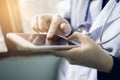 Soft focus of woman doctor hand holding and touching blank screen for work on modern smart phone in the consultation