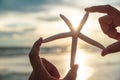 Soft focus on woman hand holding starfish over sea and Sandy Royalty Free Stock Photo