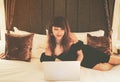 Portrait of attractive woman with laptop in bedroom
