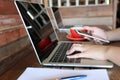 Soft focus of young woman of freelancer working using laptop computer and hand holding mobile smart phone on the wooden table in Royalty Free Stock Photo