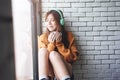 Soft Focus of Young Woman Relaxing with Music From Headphone in Cozy House Nearby Window, Enjoying with Morning Sunshine and Hot Royalty Free Stock Photo