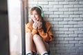 Soft Focus of Young Woman Relaxing with Music From Headphone in Cozy House Nearby Window, Enjoying with Morning Sunshine and Hot Royalty Free Stock Photo