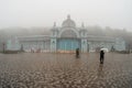 Soft focus. Zheleznovodsk Pushkin gallery in foggy autumn. People walk under umbrellas