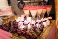 Soft focused shot of festive candy bar with cupcakes, macarons, coctail glasses and strawberries in chocolate glaze. Unfocused pin Royalty Free Stock Photo