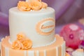 Soft focused shot of white birthday cake for girl with orange mastic rose flowers.
