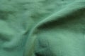Soft fold on unprinted juniper green cotton fabric Royalty Free Stock Photo