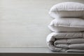 Soft folded blanket and pillows on light grey table, closeup. Space for text Royalty Free Stock Photo