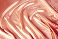 Soft folds on delicate pink shining silk, luxury concept, background for the designer, horizontal, close-up, copy space