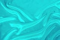 Soft folds on delicate turquoise shining silk, luxury concept, background for the designer, horizontal, close-up, copy space