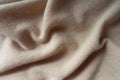 Soft folds of beige knitted fabric