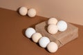 The soft fragrant bath salt bombs are on the paper box isolated on beige background. Idea for bathroom