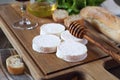 Soft French goat cheese, bread, honey, lettuce and wineglass Royalty Free Stock Photo