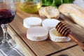 Soft French goat cheese, bread, honey, lettuce and wineglass Royalty Free Stock Photo