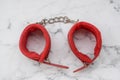 Soft fur handcuffs for role-playing games are on the table Royalty Free Stock Photo