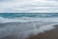 Soft and gentle waves foam tail at south Italy coast in evening Royalty Free Stock Photo