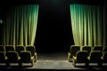 soft green velvet theater chairs contrasted by the dark stage