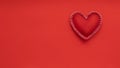 Soft handmade felt heart on red background
