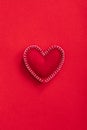 Soft handmade felt heart on red background