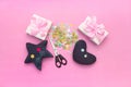 Soft handmade toys. Materials for artistic buttons, scissors, toy star.