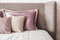 Soft Headboard and pillows in neutral beige colors. Fragment of cozy modern bedroom