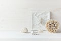 Soft home decor; shells and corals on white wooden background.