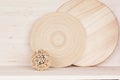 Soft home decor of wooden plate and stems on white wood background.